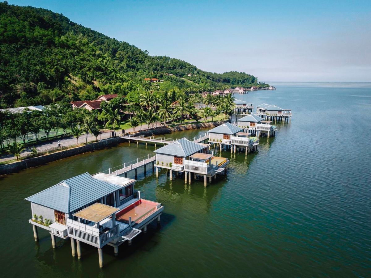 Over-water villa with its own rectangular pool on a timber deck above the lagoon
